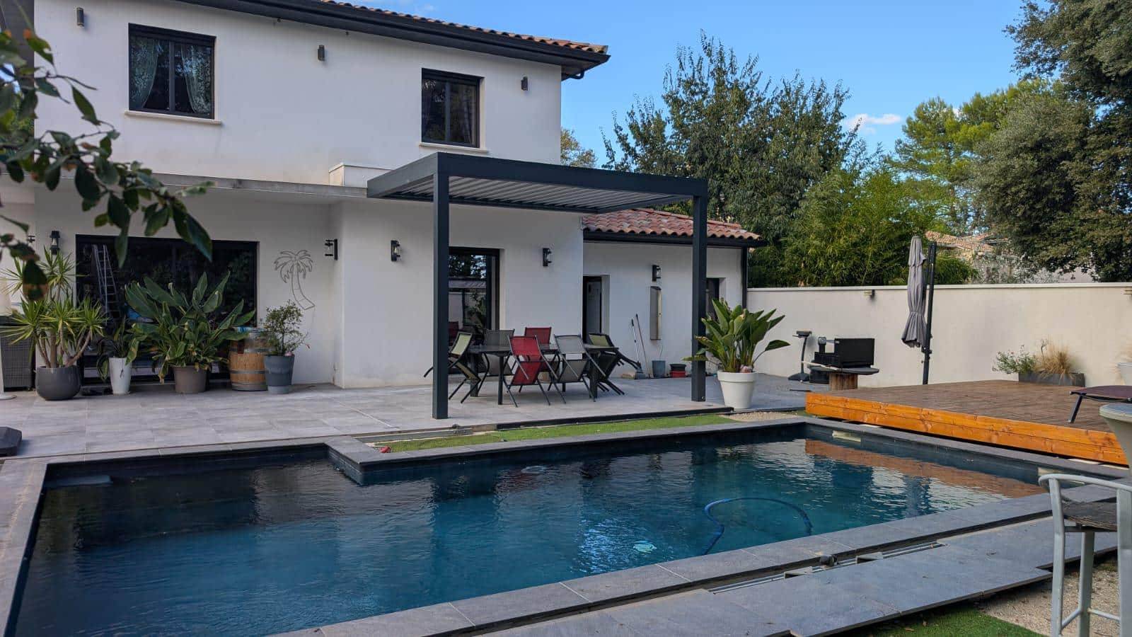 Pergola moderne en aluminium sur terrasse avec piscine extérieure
